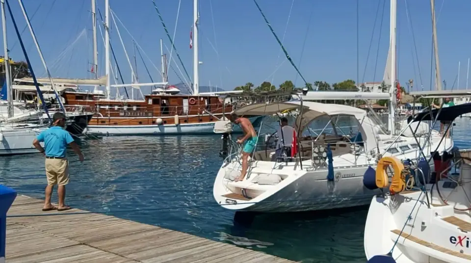 Sailing yachts moored at a wooden pontoon in the marina